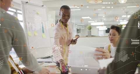 Diverse team collaborating amidst digital interface graphics