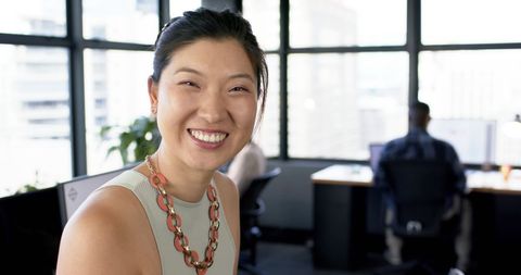 Smiling Asian Businesswoman in Modern Office