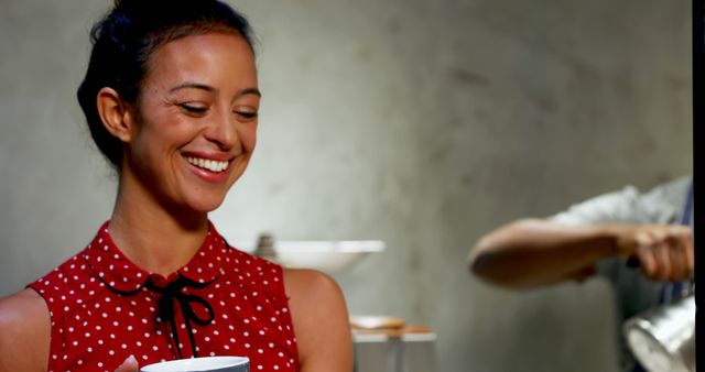 Smiling Woman Holding Coffee Cup in Cozy Cafe Setting - Download Free Stock Images Pikwizard.com