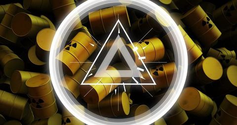 Radioactive waste barrels with hazard symbol and glowing triangle