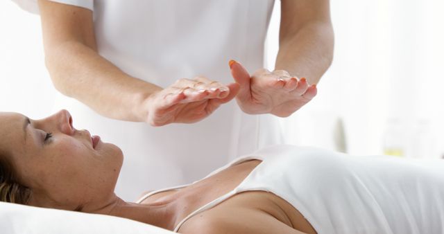 Reiki Practitioner Healing Female Patient with Hand Energy - Download Free Stock Images Pikwizard.com