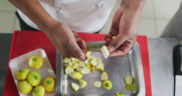 Midsection of biracial male chef cutting vegetable in restaurant kitchen - Download Free Stock Photos Pikwizard.com