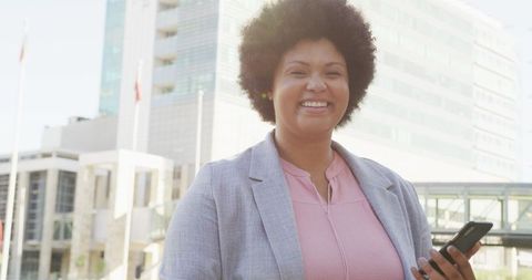 Happy Plus Size Woman Using Smartphone in Urban Environment