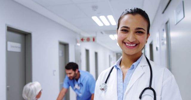 Smiling Female Doctor in Hallway of Modern Hospital - Download Free Stock Images Pikwizard.com