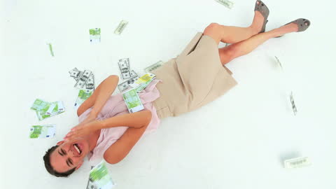 Joyful Woman Rolling in Money on White Background