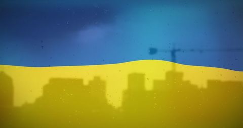 Ukraine Flag and Urban Skyline Silhouette in Raindrops