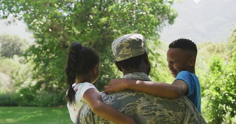 African American Soldier Embracing Children in Sunny Garden - Download Free Stock Images Pikwizard.com