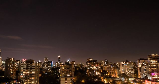 General view of busy cityscape at night with modern buildings and dark sky - Download Free Stock Photos Pikwizard.com
