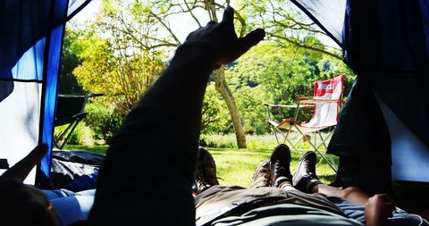 Relaxing Inside Tent with Open View to Lush Camping Scene
