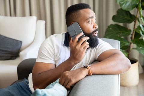 Casual African American Man on Phone Relaxing at Home