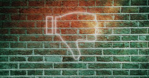 Illuminated Thumbs Down Sign on Brick Wall Symbolizing Dislike - Download Free Stock Images Pikwizard.com