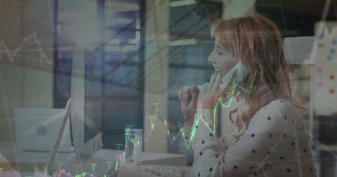 Woman Analyzing Financial Data on Phone in Office