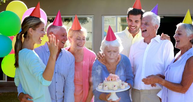 Doctors and senior citizen celebrating birthday at home