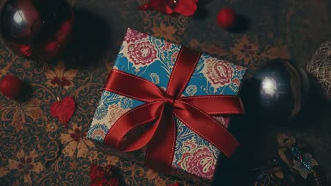 Hands Carefully Unwrapping Colorful Gift Box for Special Occasion