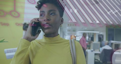 Young professional woman using smartphone in modern office
