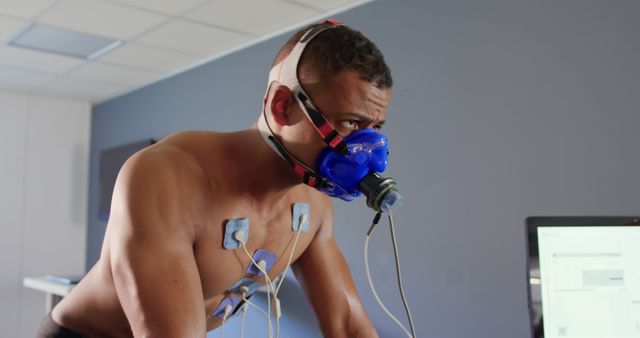 Man Undergoing Fitness Testing on Stationary Bike with Respiratory Mask - Download Free Stock Images Pikwizard.com