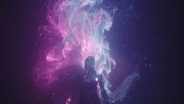 Silhouette in mystical nebula with luminescent particles