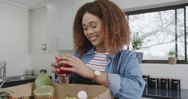 Happy Woman Unpacking Grocery Box in Kitchen - Download Free Stock Images Pikwizard.com