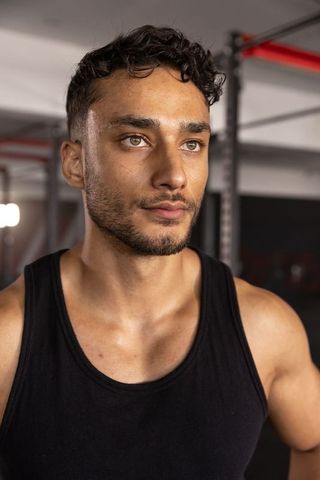 Confident athlete preparing for weightlifting in gym environment
