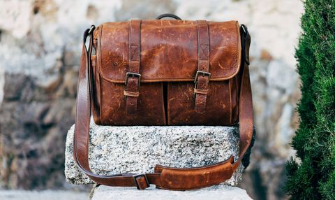 Vintage Brown Leather Satchel on Stone Bench