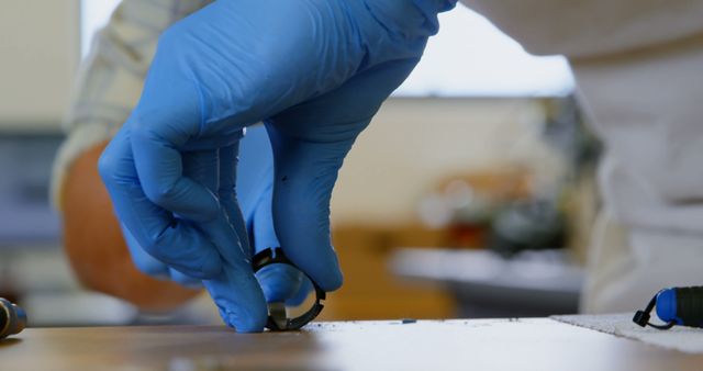 Close-Up of Technician Wearing Blue Gloves Working with Precision Instrument - Download Free Stock Images Pikwizard.com