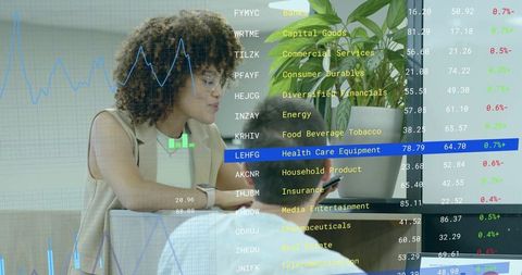 Financial analyst reviewing stock data in modern office lounge