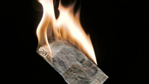 Burning Euro Note Against Dark Background in Slow Motion