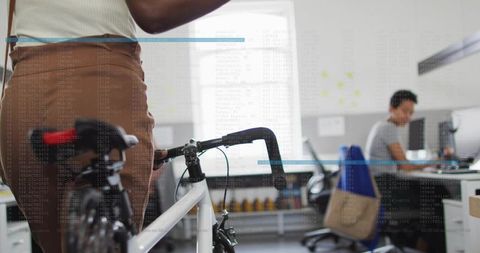 Professional in open office with bicycle, embracing modern work culture