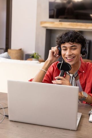 Young podcaster creating content from home studio