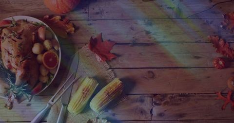Rustic thanksgiving roast chicken with grilled corn and autumn harvest table flatlay