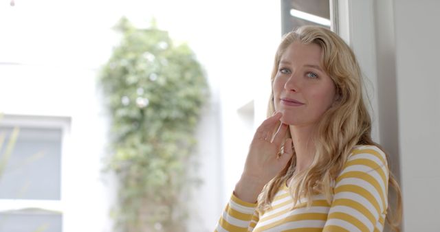 Thoughtful Female Contemplating at Home in Striped Shirt - Download Free Stock Images Pikwizard.com