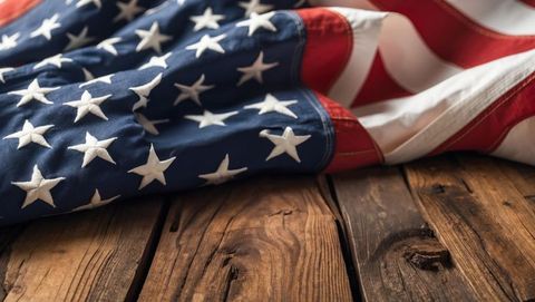 Folded American Flag Draping Over Rustic Wooden Planks