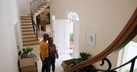 Couple moving into new home unpacking boxes