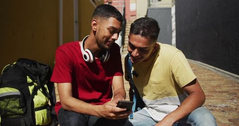 Friends Backpacking and Exploring City Together with Smartphone
