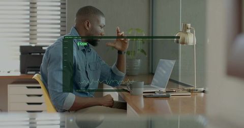 Man analyzing $120k financial dashboard on laptop while working at tidy home office desk