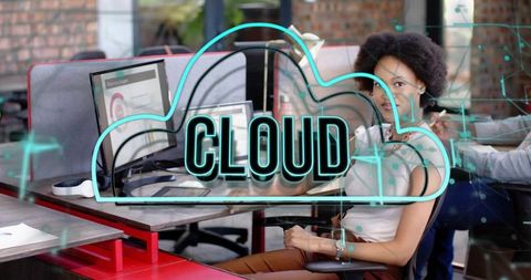 Woman collaborating at dual-monitor workspace with neon cloud overlay and network data visualization