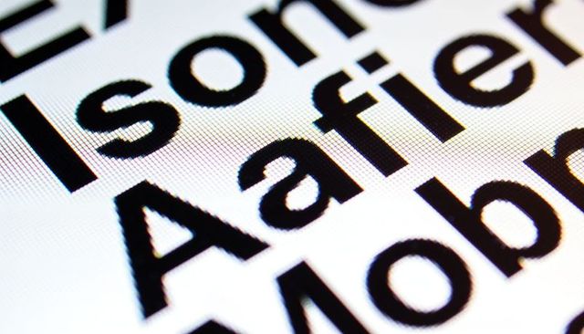 Macro typography closeup showing magnified capital a and rgb subpixel grid backlit screen