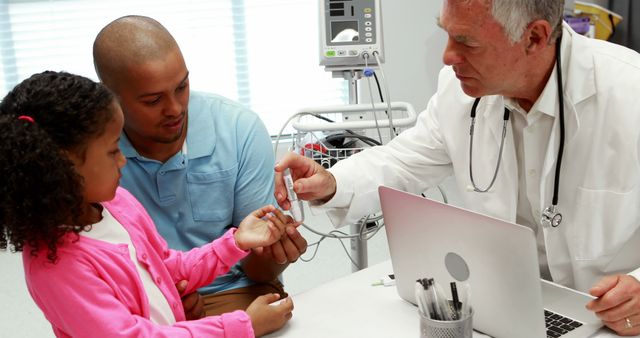 Doctor Giving Medical Advice to Child with Parent in Examination Room - Download Free Stock Images Pikwizard.com