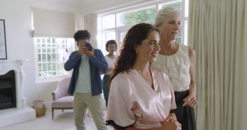 Bride in Silken Robe Enjoying Wedding Day Preparations with Family