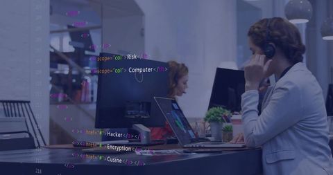 Support agent wearing headset working at laptop with cybersecurity code overlay in office