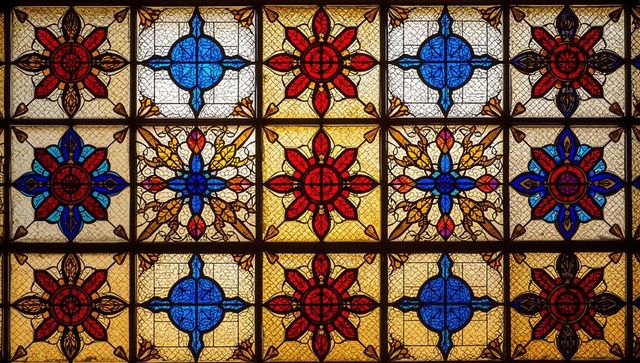 Vibrant stained glass pattern with red and blue ornaments