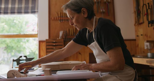 Senior Craftsperson Working on Wood Project in Workshop - Download Free Stock Images Pikwizard.com