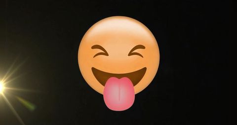 Playful Tongue Out Emoji with Lens Flare on Black Background
