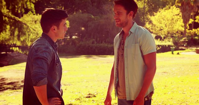 Two Men Conversing in Park During Sunny Day - Download Free Stock Images Pikwizard.com