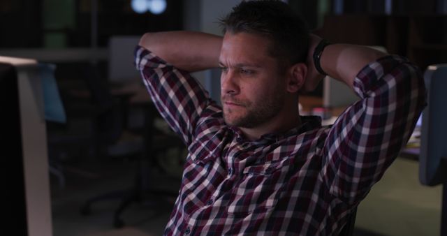 Young Male Professional Contemplating at Desk in Casual Office Environment - Download Free Stock Images Pikwizard.com