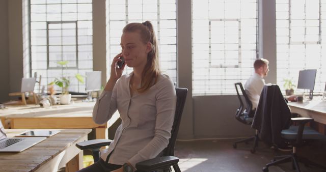 Woman Talking on Phone in Modern Office Space - Download Free Stock Images Pikwizard.com