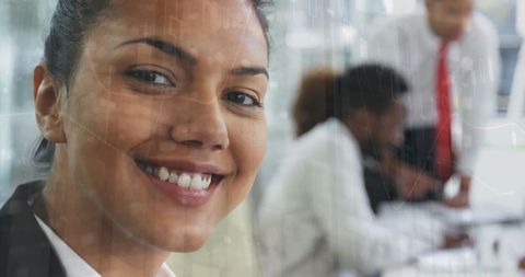 Smiling Businesswoman Engages in Teamwork with Modern Technology Overlay