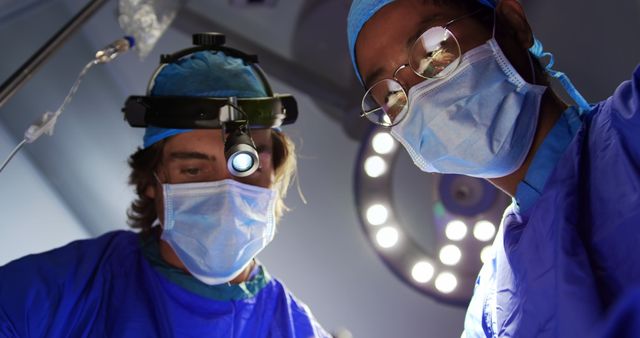 Surgeons Performing Intense Surgery Under Surgical Lights - Download Free Stock Images Pikwizard.com