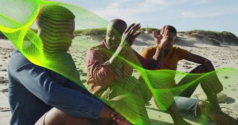 Three men sitting on beach chatting with neon green mesh overlay for creative tech concept