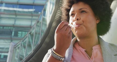 Plus Size Woman Enjoys Healthy Snack in Urban Environment